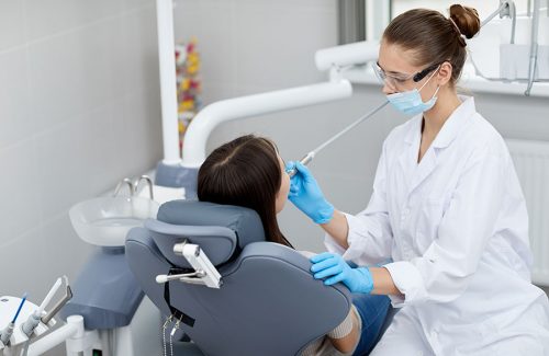 female-dentist-working-with-patient-PTE6ZA7.jpg